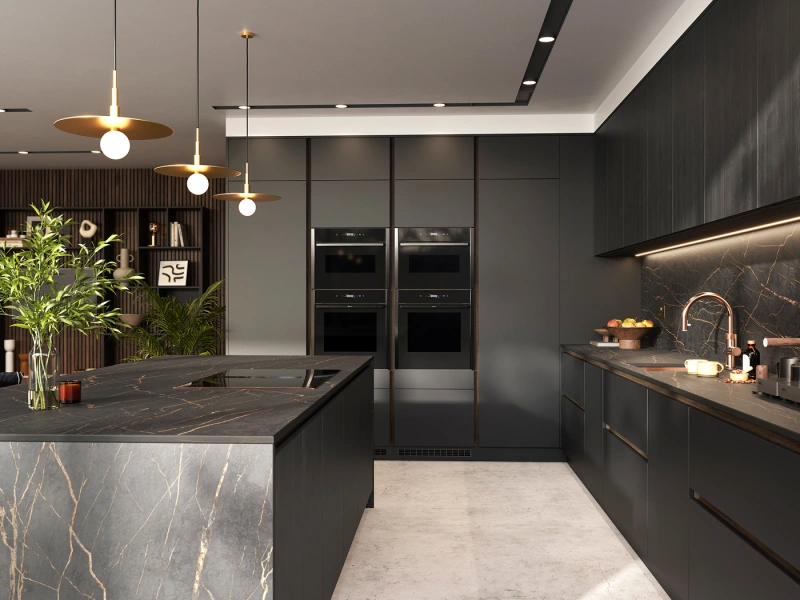 Modern luxury kitchen with dark grey cabinetry, marble-effect countertops with gold veining, built-in black ovens, gold pendant lights, under-cabinet lighting, a central island with integrated hob, decorative plant arrangement, and dark marble backsplash with copper rose gold tap, set against a grey and white ceiling with recessed lighting.