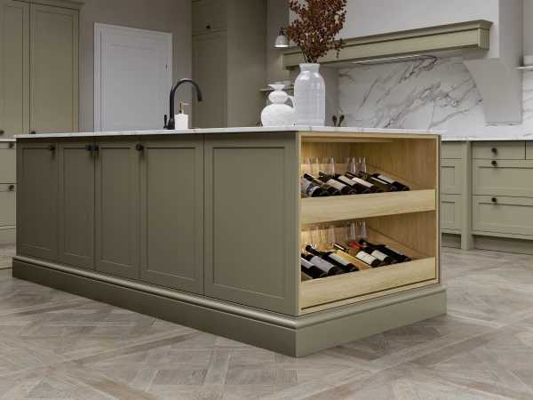 Modern sage green kitchen with a central island featuring wine storage, white marble backsplash and countertops, pendant lighting, dried flower arrangement, and matching cabinetry throughout