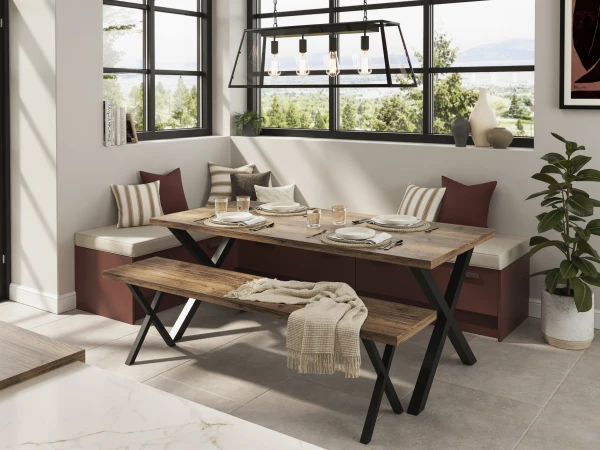 Modern dining nook with built-in burgundy seating, wooden table, black bench, pendant lights, and floor-to-ceiling windows overlooking landscape.