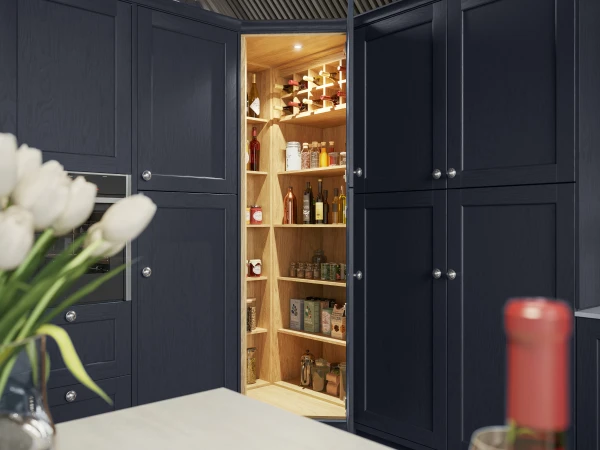 Dark cabinetry with open doors revealing illuminated wooden shelving filled with kitchen pantry items.