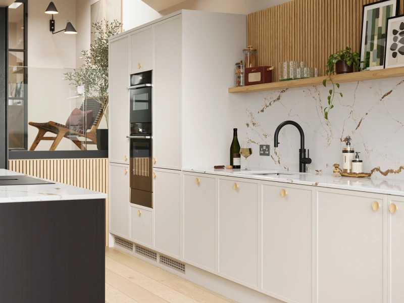 Modern kitchen interior with white cabinetry, marble backsplash and wooden worktops, featuring integrated appliances, black tap, open shelving with plants and decorative items, pendant lights, wooden flooring, and a skylight above, with a lounge area visible through glass partition on the left
