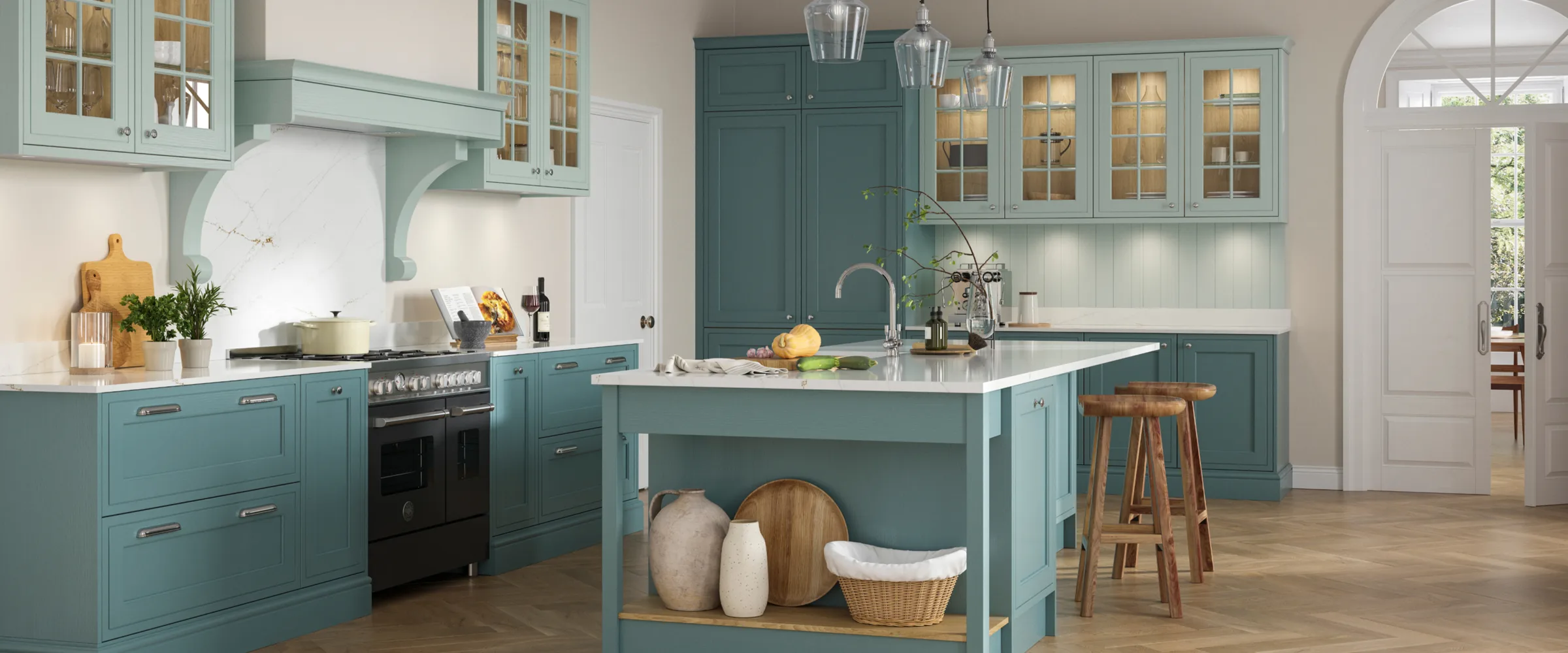Teal kitchen with island, white countertops, pendant lights, and wooden bar stools.
