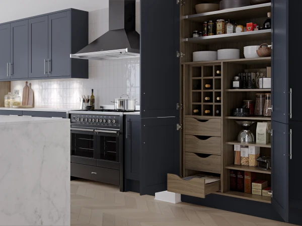 Modern kitchen with navy cabinetry, marble countertop, black range cooker, and integrated wooden storage unit with wine rack and shelving.