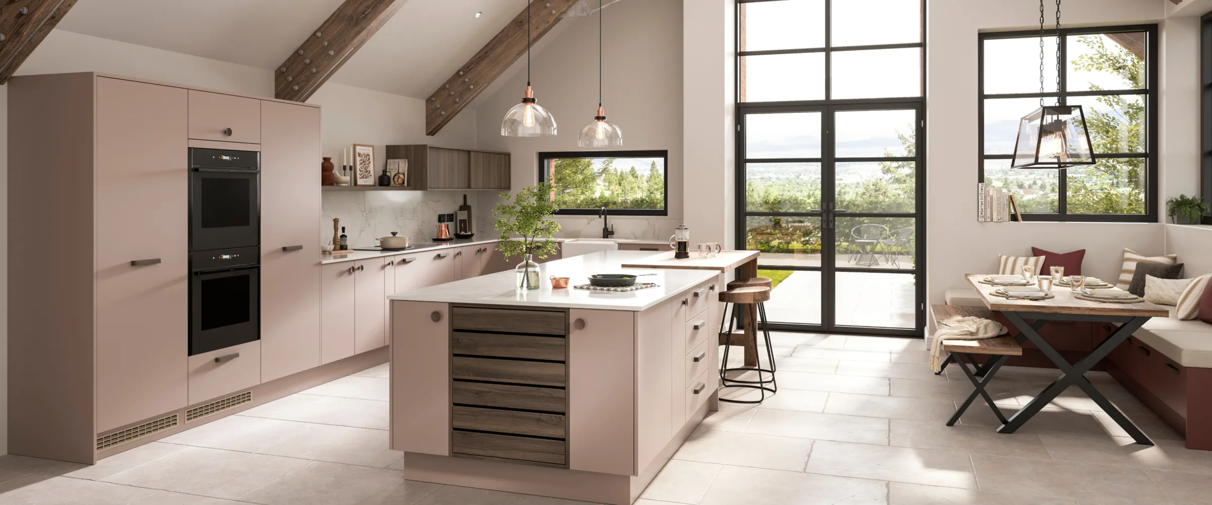 Modern kitchen with pink cabinetry, island, and open-plan living area with windows and exposed beams.
