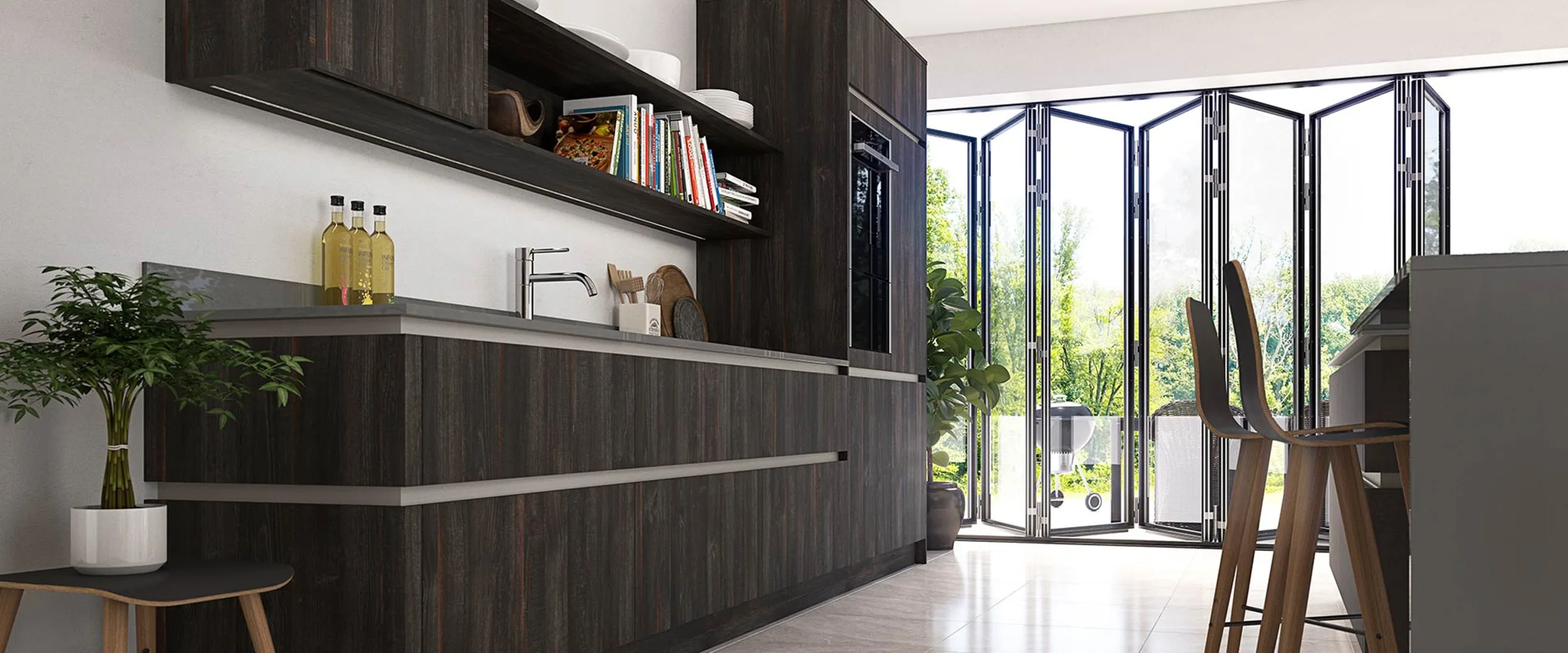 Modern kitchen with dark wood cabinetry, grey shelving units holding books and decorative items, stainless steel sink and tap, potted plant on wooden stool, and bi-fold glass doors opening onto a garden with outdoor seating area