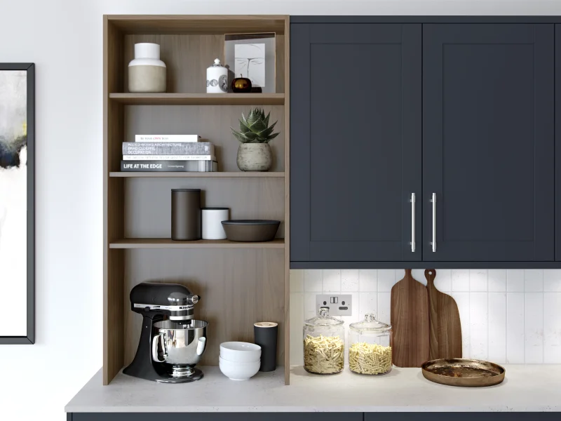 Modern kitchen with dark cabinetry, open shelving, white subway tile, and styled accessories including a mixer and potted plant.