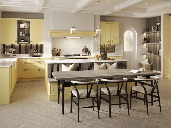 Modern kitchen with yellow cabinets, white marble countertops and backsplash, featuring a large island with seating, dining table with black chairs, stainless steel appliances, coffered ceiling with pendant lights, and neutral walls with open shelving and arched window.