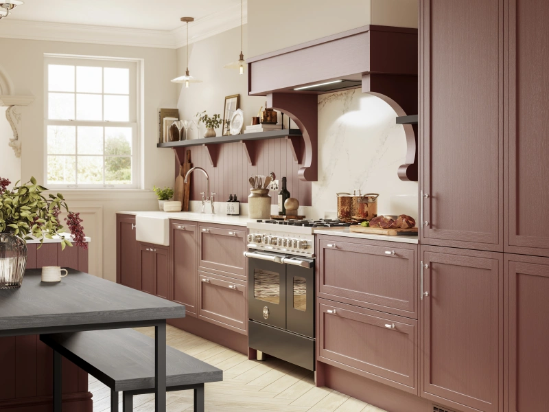 Modern kitchen with burgundy cabinetry, marble worktops, pendant lights, and black dining table.