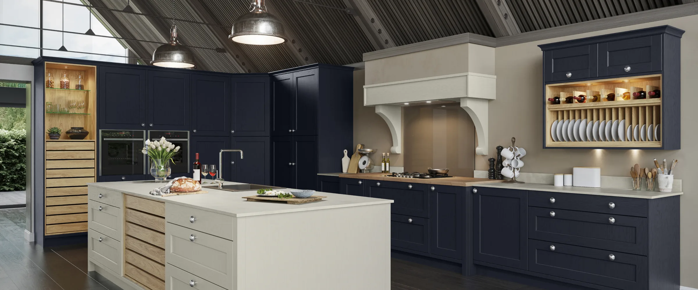 Modern kitchen showroom with navy and cream cabinetry, island, and open shelving displaying crockery.