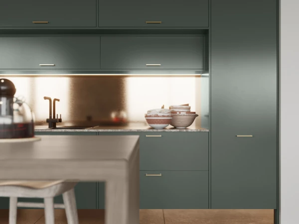 Modern kitchen with dark green cabinetry, integrated appliances, copper backsplash, open shelving with cookware, white bar stools at peninsula counter, and minimalist brass handles