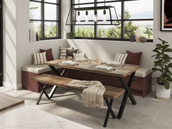 Modern dining nook with built-in burgundy seating, wooden table, black bench, pendant lights, and floor-to-ceiling windows overlooking landscape.