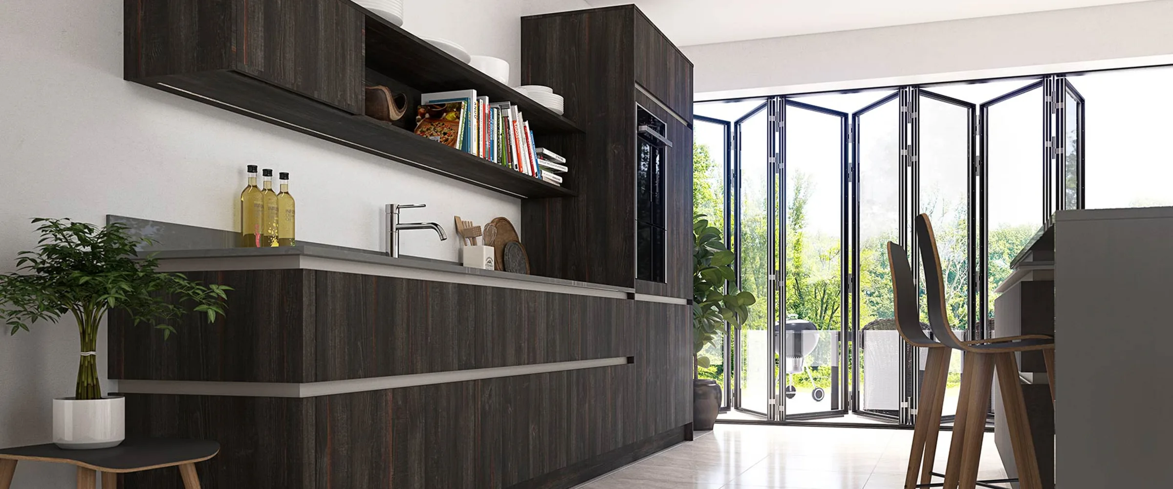 Modern kitchen with dark wood cabinetry, open shelving displaying books and decorative items, stainless steel sink and tap, white walls, potted plants, and folding glass doors opening to an outdoor garden area with wooden bar stools at the counter.